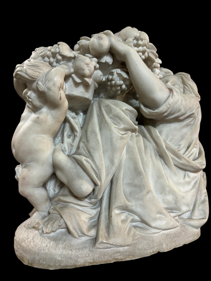 19th century Carrara marble sculpture of a woman and putti carrying baskets of fruit. A Renaissance decorative marble sculpture of a woman and putti carrying baskets of fruit. The sculpture is signed by Levasseur ( Paris 1853-1934 )