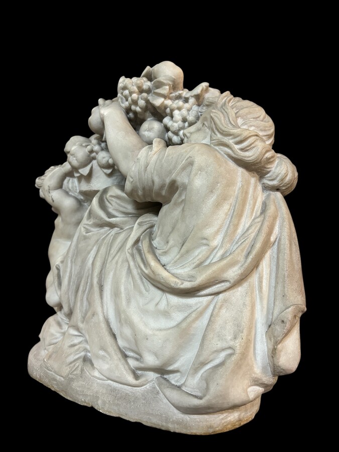 19th century Carrara marble sculpture of a woman and putti carrying baskets of fruit. A Renaissance decorative marble sculpture of a woman and putti carrying baskets of fruit. The sculpture is signed by Levasseur ( Paris 1853-1934 )