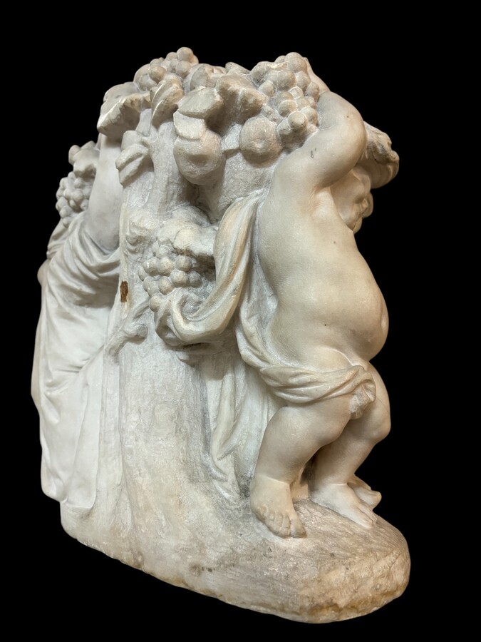 19th century Carrara marble sculpture of a woman and putti carrying baskets of fruit. A Renaissance decorative marble sculpture of a woman and putti carrying baskets of fruit. The sculpture is signed by Levasseur ( Paris 1853-1934 )