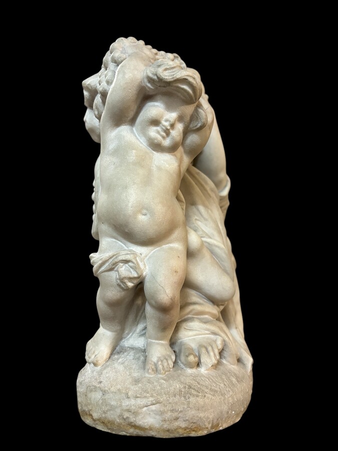 19th century Carrara marble sculpture of a woman and putti carrying baskets of fruit. A Renaissance decorative marble sculpture of a woman and putti carrying baskets of fruit. The sculpture is signed by Levasseur ( Paris 1853-1934 )