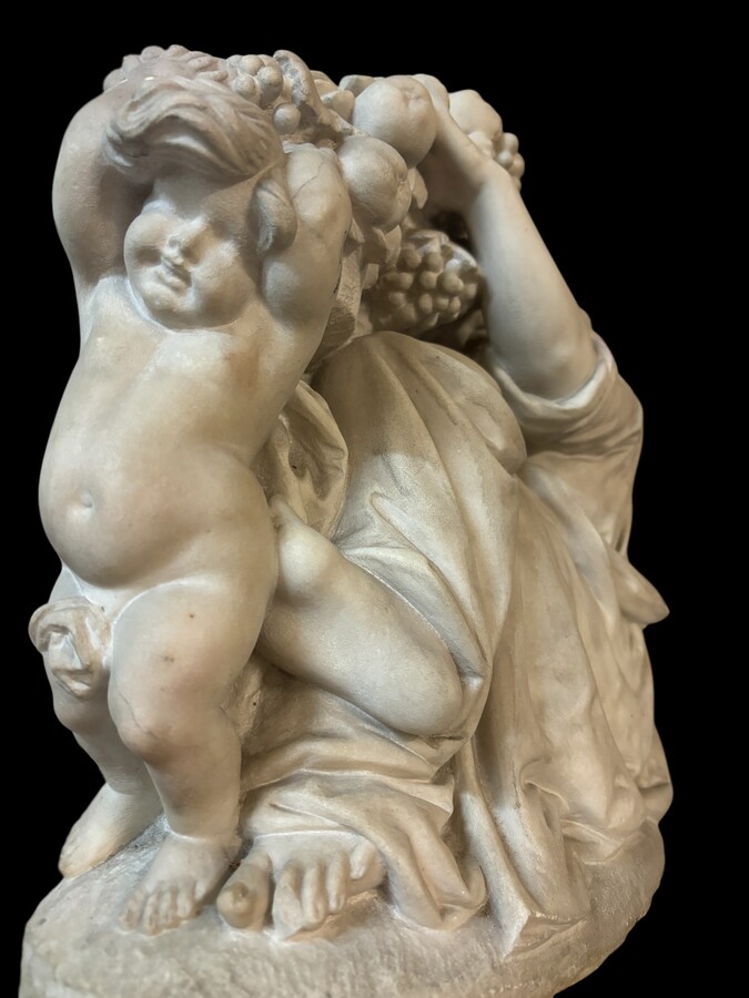 19th century Carrara marble sculpture of a woman and putti carrying baskets of fruit. A Renaissance decorative marble sculpture of a woman and putti carrying baskets of fruit. The sculpture is signed by Levasseur ( Paris 1853-1934 )