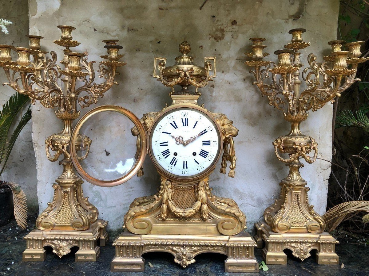 A Large Gilt Bronze LXVI Style Mantelpiece Paris, 19th Century. The Clock And The Candelabras Are Gilded With Matt And Bright Gold. Clock Signed By G.Philippe, Palais Royal 66 & 67 In Paris. Dimensions Clock: 68 Cm High, 42 Cm Wide And 24 Cm Deep.