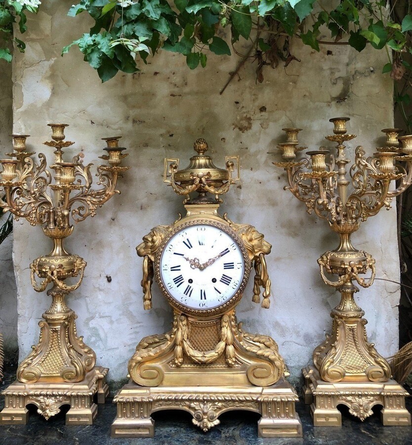 A Large Gilt Bronze LXVI Style Mantelpiece Paris, 19th Century. The Clock And The Candelabras Are Gilded With Matt And Bright Gold. Clock Signed By G.Philippe, Palais Royal 66 & 67 In Paris. Dimensions Clock: 68 Cm High, 42 Cm Wide And 24 Cm Deep.