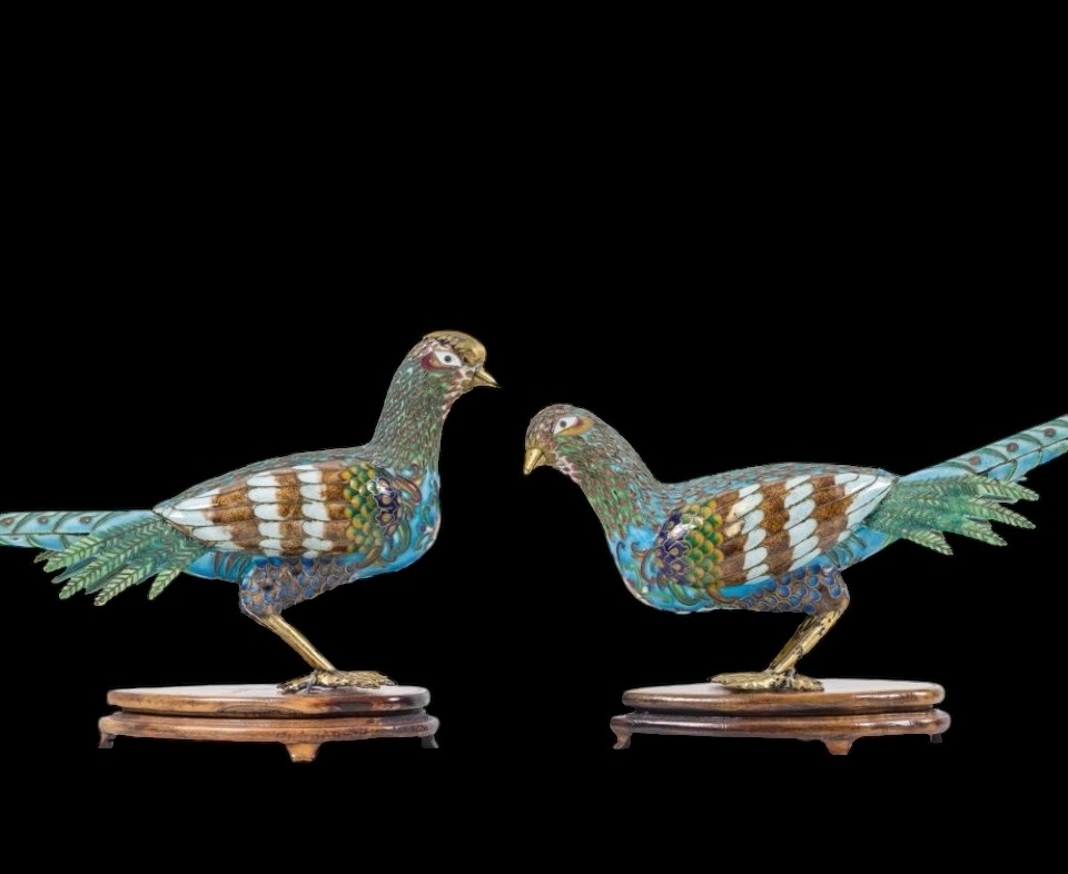 A pair of pheasants in finely crafted emaille cloisonné. 20th century. Decorative pair of sculptures standing on a wooden base Dimensions : Rooster: 19 x 37 cm. (incl. base)  Hen: 18 x 38 cm. (incl. base)  In good condition with a small peeling on the hen