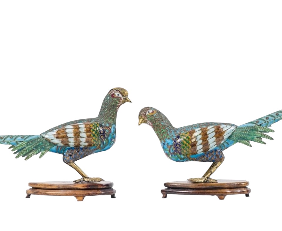 A pair of pheasants in finely crafted emaille cloisonné. 20th century. Decorative pair of sculptures standing on a wooden base Dimensions : Rooster: 19 x 37 cm. (incl. base)  Hen: 18 x 38 cm. (incl. base)  In good condition with a small peeling on the hen