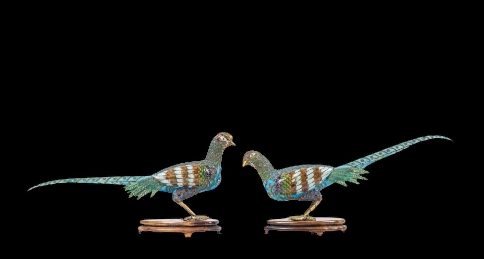 A pair of pheasants in finely crafted emaille cloisonné. 20th century. Decorative pair of sculptures standing on a wooden base Dimensions : Rooster: 19 x 37 cm. (incl. base)  Hen: 18 x 38 cm. (incl. base)  In good condition with a small peeling on the hen