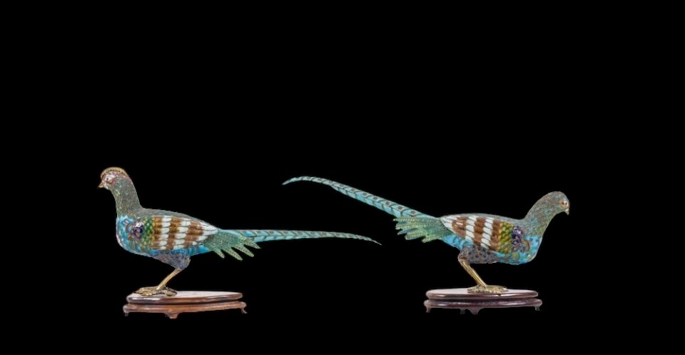 A pair of pheasants in finely crafted emaille cloisonné. 20th century. Decorative pair of sculptures standing on a wooden base Dimensions : Rooster: 19 x 37 cm. (incl. base)  Hen: 18 x 38 cm. (incl. base)  In good condition with a small peeling on the hen