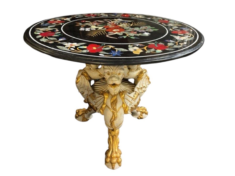 Beautiful guéridon with inlaid marble top on unusual wooden base. Large round table top in Italian pietra dura with flowers and beautiful colours on a beautiful ‘winged mythological beasts’ base 