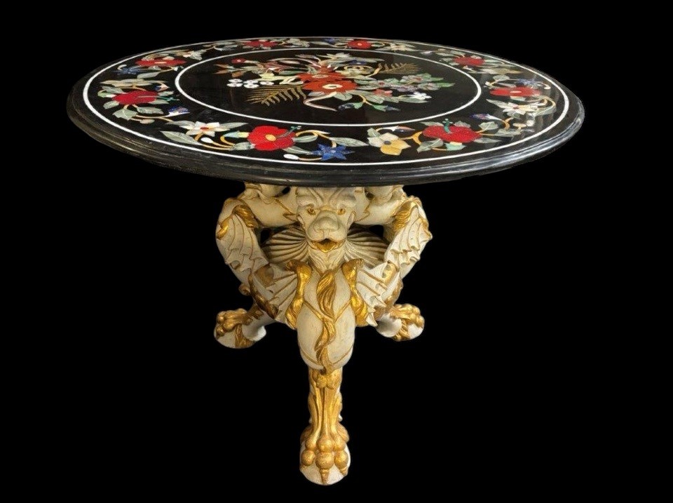 Beautiful guéridon with inlaid marble top on unusual wooden base. Large round table top in Italian pietra dura with flowers and beautiful colours on a beautiful ‘winged mythological beasts’ base 