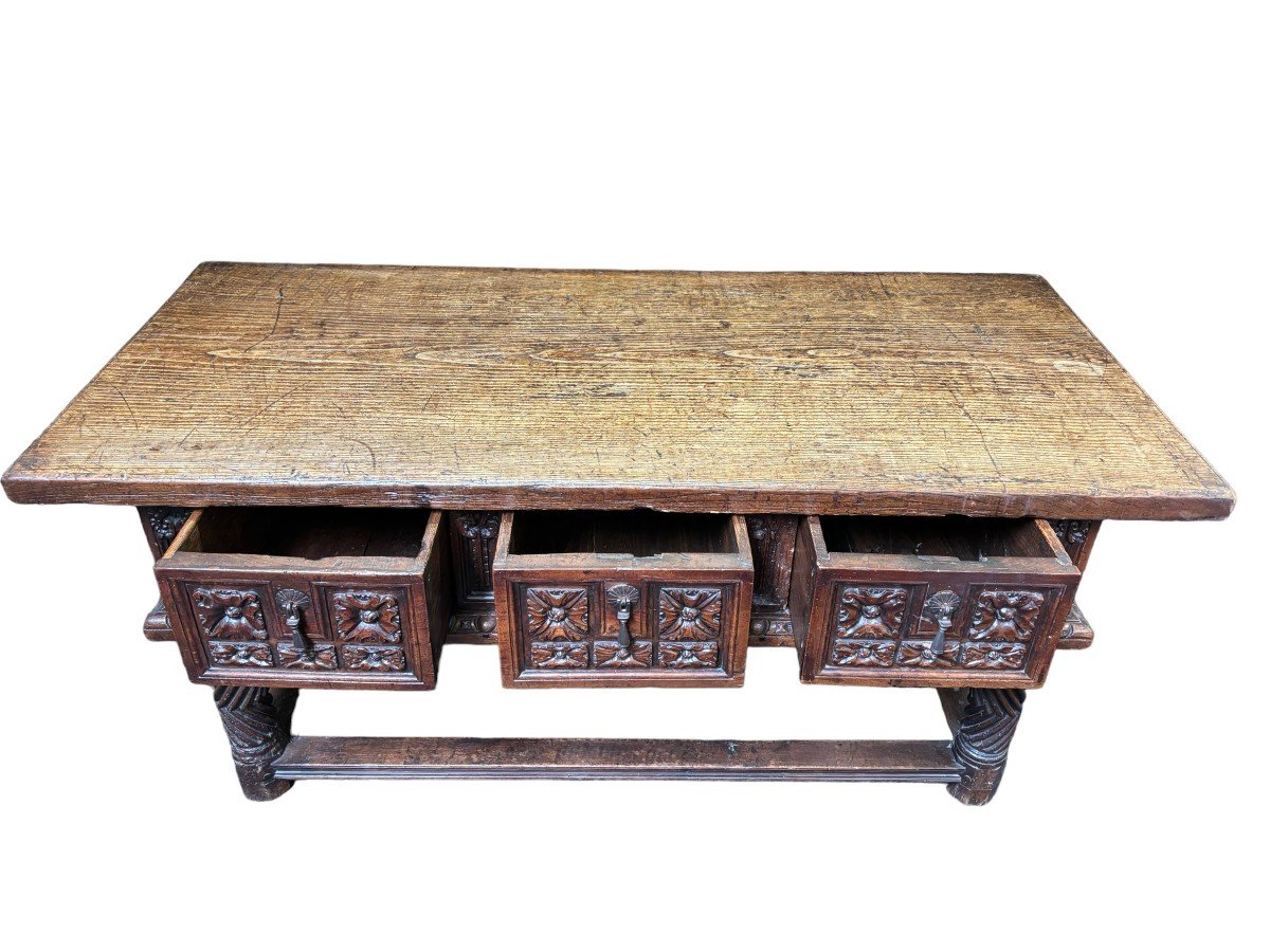 Beautiful Spanish table in Chestnut wood 17th century. Large sturdy table finished on 4 sides with beautiful wood carved decorations and fitted with 3 large drawers at the front. Beautiful thick top of 5 cm. Table in good condition