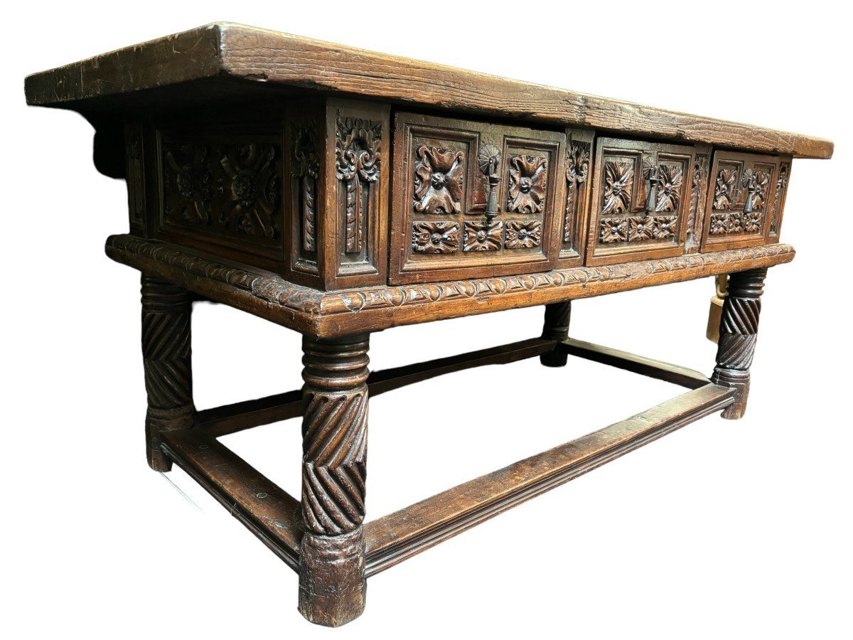 Beautiful Spanish table in Chestnut wood 17th century. Large sturdy table finished on 4 sides with beautiful wood carved decorations and fitted with 3 large drawers at the front. Beautiful thick top of 5 cm. Table in good condition