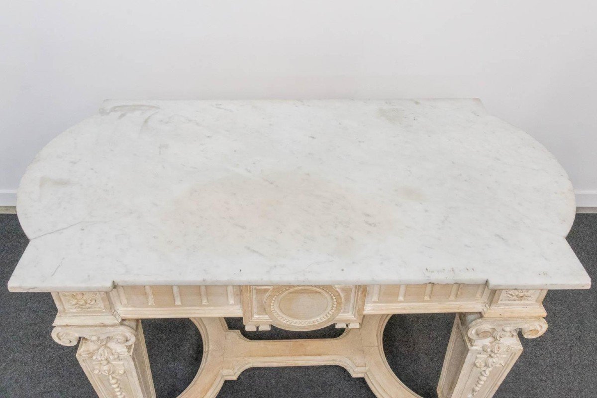 Decorative console of sculpted wood Louis XVI style late 19th century. Model with iconic columns minor damages and crack in marble top. Dimensions : Width: 125 cm Height: 87 cm Depth: 65,5 cm