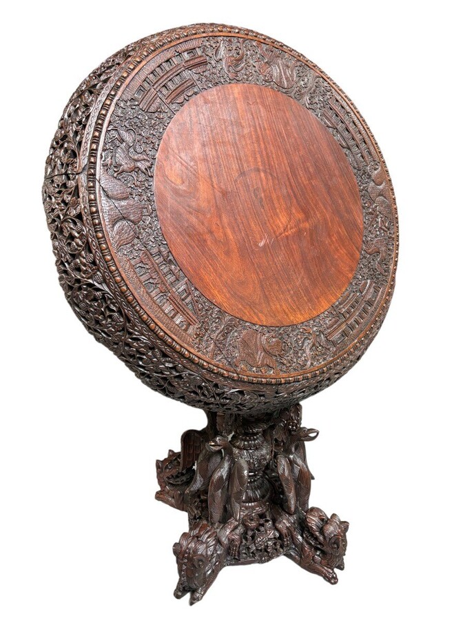 Finely sculpted centre table in hardwood 19th century. Decorated with dragons , birds , animals and temples Folding top , in good condition. Dimensions : Height : 78 cm Diameter top : 84 cm Nice table from Burma , 19thC