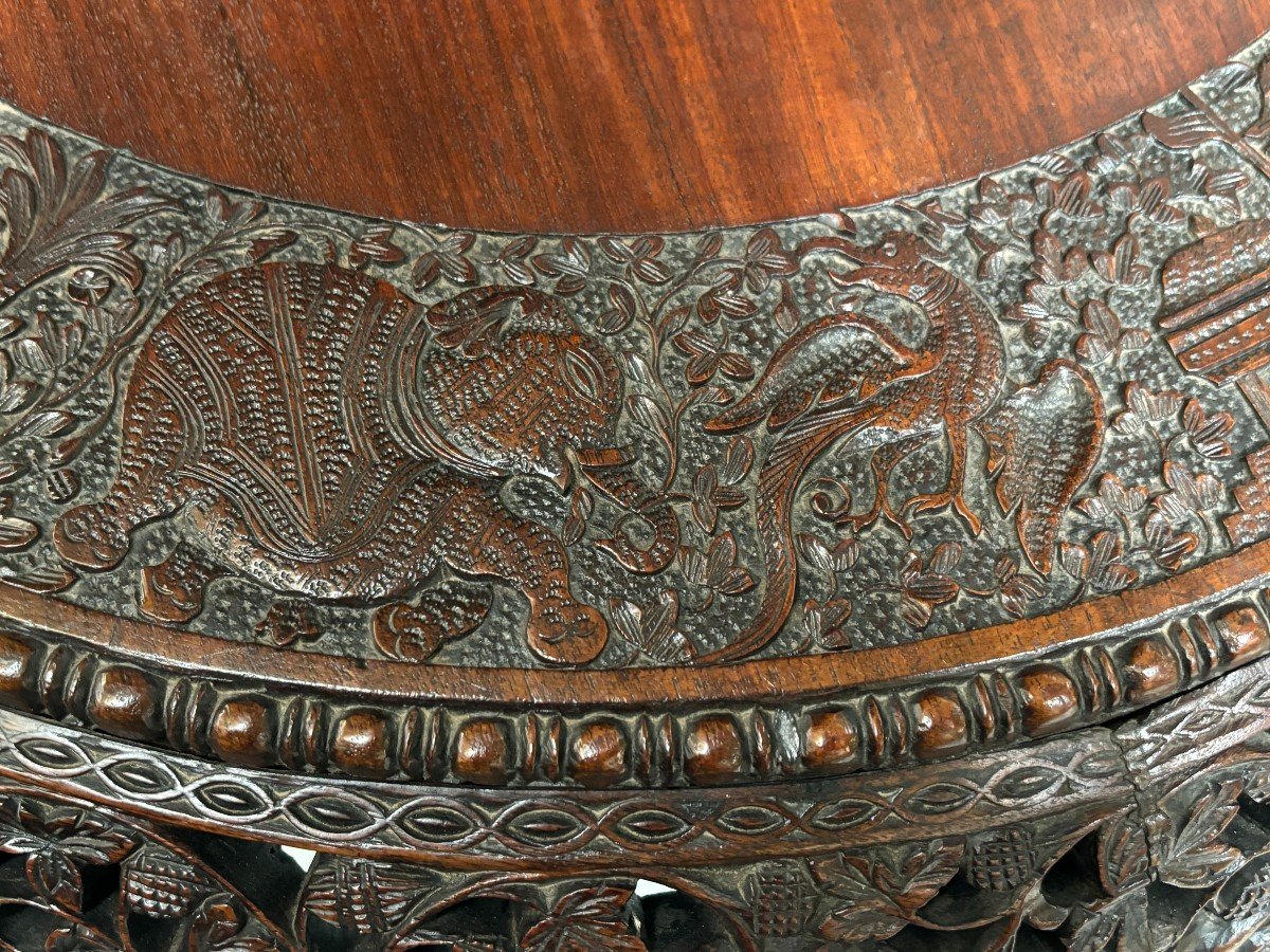 Finely sculpted centre table in hardwood 19th century. Decorated with dragons , birds , animals and temples Folding top , in good condition. Dimensions : Height : 78 cm Diameter top : 84 cm Nice table from Burma , 19thC