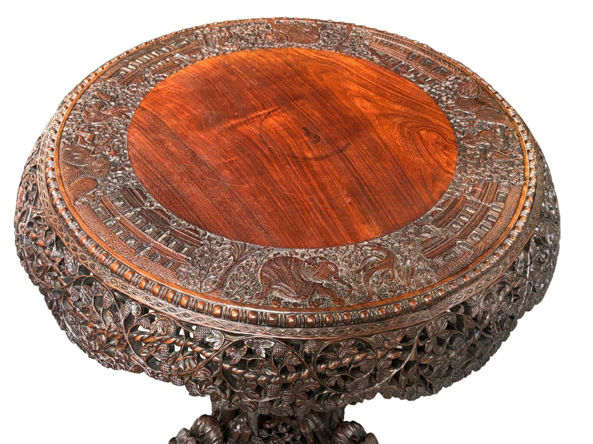 Finely sculpted centre table in hardwood 19th century. Decorated with dragons , birds , animals and temples Folding top , in good condition. Dimensions : Height : 78 cm Diameter top : 84 cm Nice table from Burma , 19thC