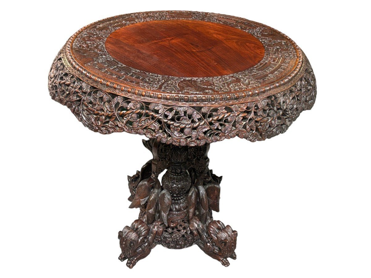 Finely sculpted centre table in hardwood 19th century. Decorated with dragons , birds , animals and temples Folding top , in good condition. Dimensions : Height : 78 cm Diameter top : 84 cm Nice table from Burma , 19thC