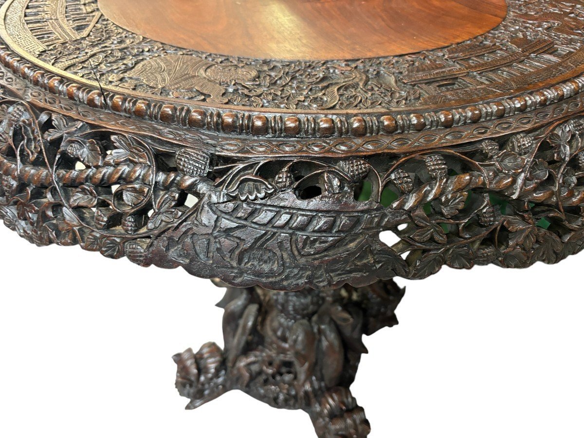 Finely sculpted centre table in hardwood 19th century. Decorated with dragons , birds , animals and temples Folding top , in good condition. Dimensions : Height : 78 cm Diameter top : 84 cm Nice table from Burma , 19thC