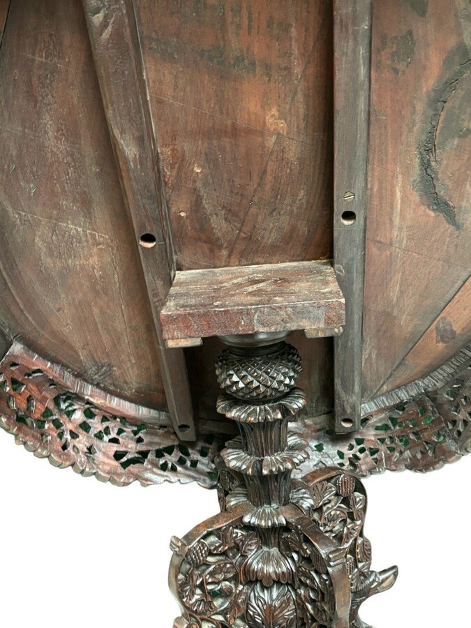 Finely sculpted centre table in hardwood 19th century. Decorated with dragons , birds , animals and temples Folding top , in good condition. Dimensions : Height : 78 cm Diameter top : 84 cm Nice table from Burma , 19thC