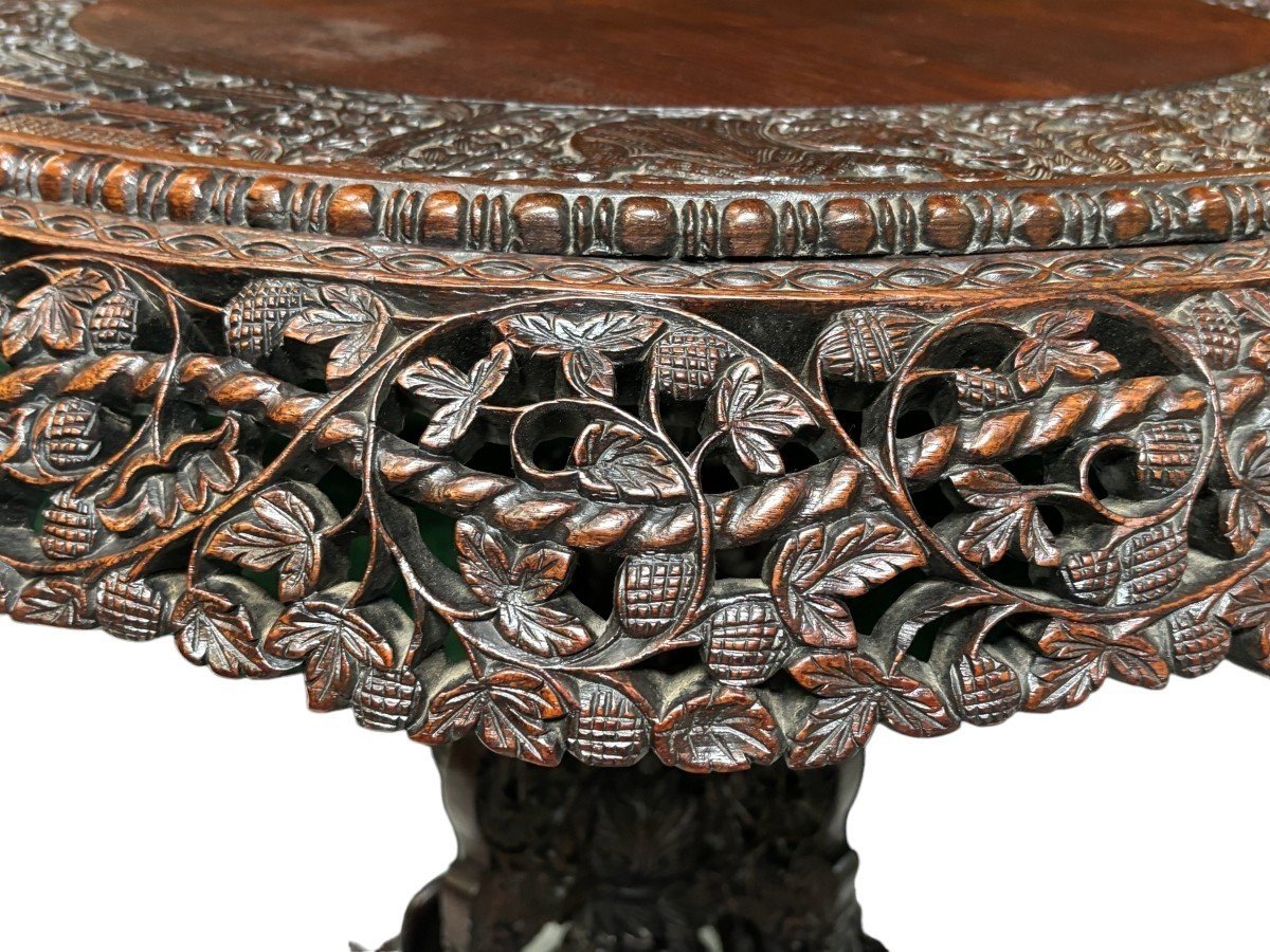 Finely sculpted centre table in hardwood 19th century. Decorated with dragons , birds , animals and temples Folding top , in good condition. Dimensions : Height : 78 cm Diameter top : 84 cm Nice table from Burma , 19thC