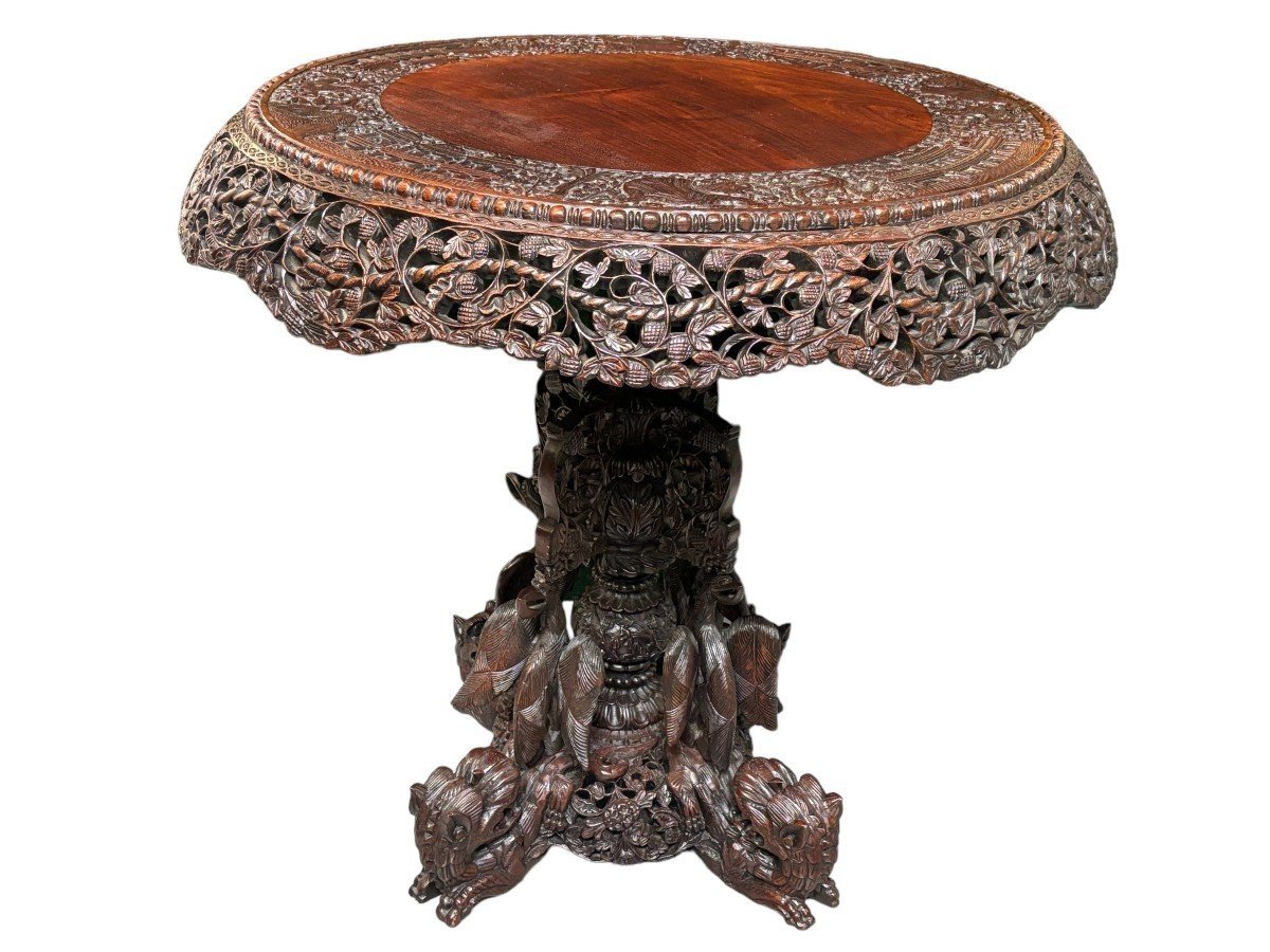 Finely sculpted centre table in hardwood 19th century. Decorated with dragons , birds , animals and temples Folding top , in good condition. Dimensions : Height : 78 cm Diameter top : 84 cm Nice table from Burma , 19thC