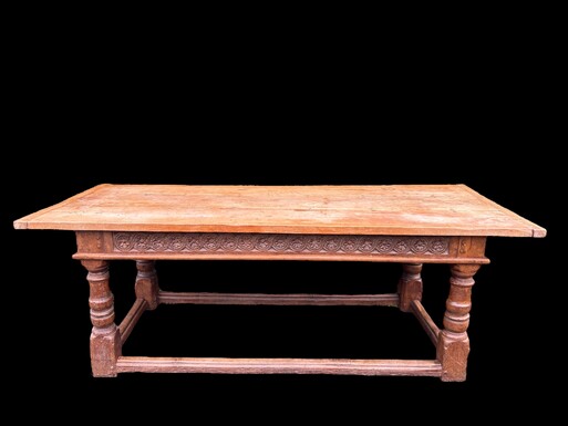 Large 18th century English oak table A very sturdy and decorative table with a carved floral border and thick baluster legs with crossbars. Table with beautiful patina and thick top in good condition. Dimensions: Width: 224 cm Height : 78,5 cm Depth : 89 