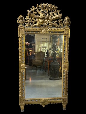 Large 18th century LXVI period mirror in gilded wood ( 184 cm ) Decorative mirror in carved, gilded and patinated wood. Dimensions : Height : 184 cm Width : 85 cm Depth : 5 cm In good condition, 18th century