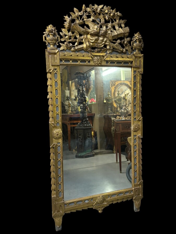 Large 18th century LXVI period mirror in gilded wood ( 184 cm ) Decorative mirror in carved, gilded and patinated wood. Dimensions : Height : 184 cm Width : 85 cm Depth : 5 cm In good condition, 18th century