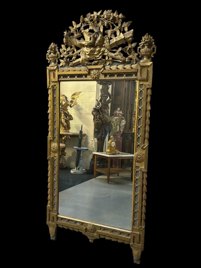 Large 18th century LXVI period mirror in gilded wood ( 184 cm ) Decorative mirror in carved, gilded and patinated wood. Dimensions : Height : 184 cm Width : 85 cm Depth : 5 cm In good condition, 18th century