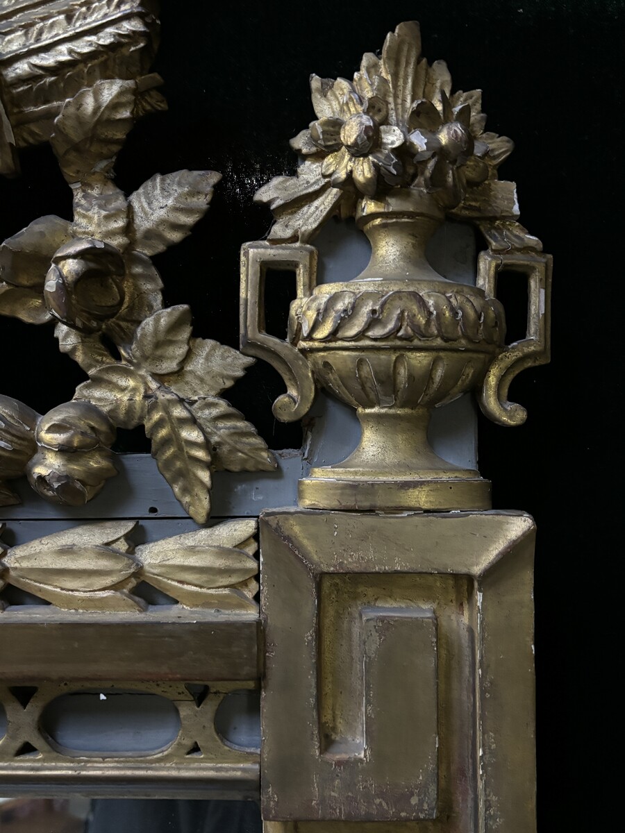 Large 18th century LXVI period mirror in gilded wood ( 184 cm ) Decorative mirror in carved, gilded and patinated wood. Dimensions : Height : 184 cm Width : 85 cm Depth : 5 cm In good condition, 18th century