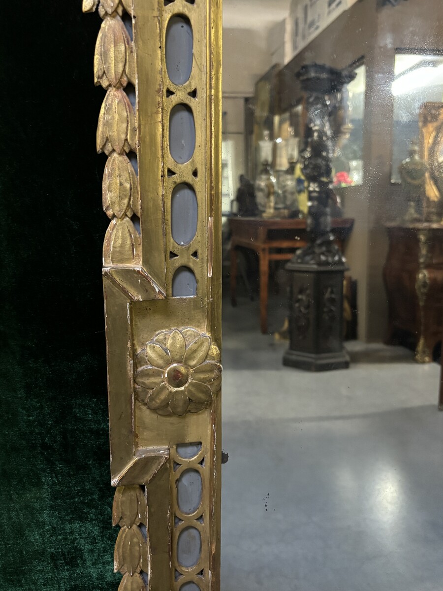 Large 18th century LXVI period mirror in gilded wood ( 184 cm ) Decorative mirror in carved, gilded and patinated wood. Dimensions : Height : 184 cm Width : 85 cm Depth : 5 cm In good condition, 18th century