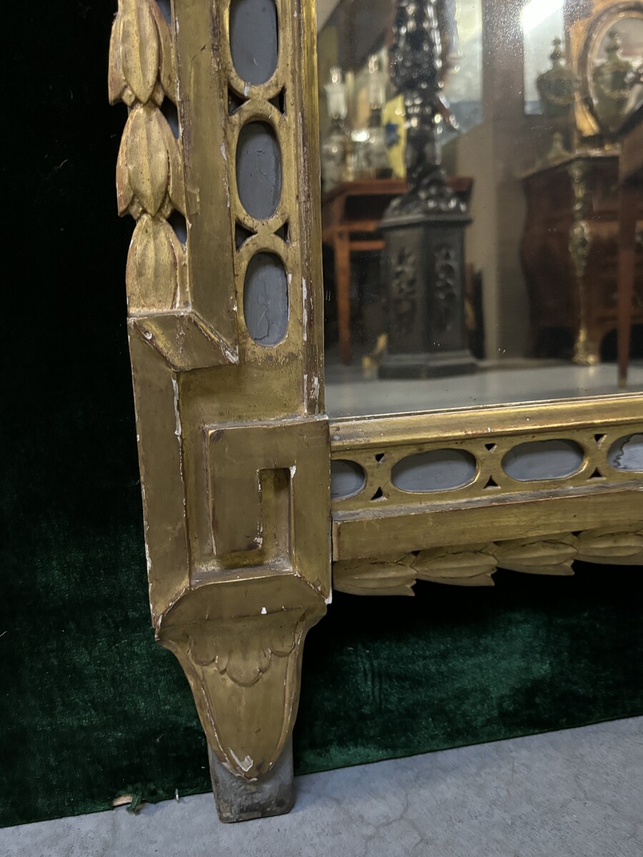 Large 18th century LXVI period mirror in gilded wood ( 184 cm ) Decorative mirror in carved, gilded and patinated wood. Dimensions : Height : 184 cm Width : 85 cm Depth : 5 cm In good condition, 18th century