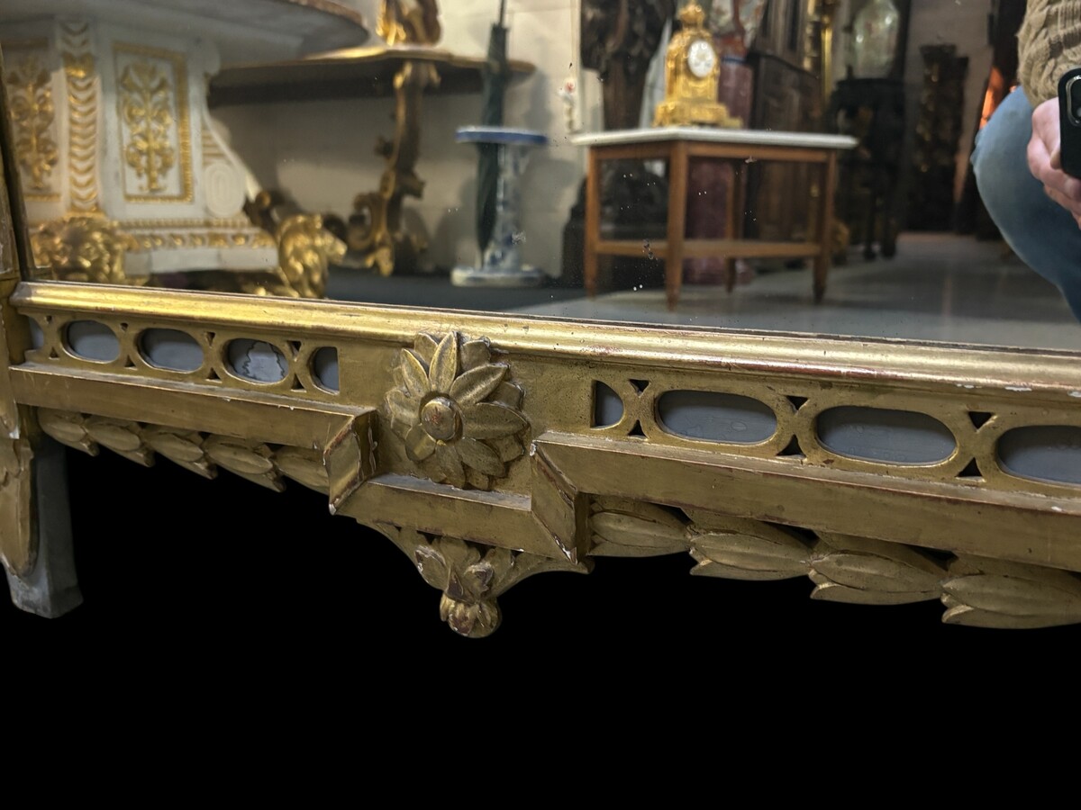 Large 18th century LXVI period mirror in gilded wood ( 184 cm ) Decorative mirror in carved, gilded and patinated wood. Dimensions : Height : 184 cm Width : 85 cm Depth : 5 cm In good condition, 18th century