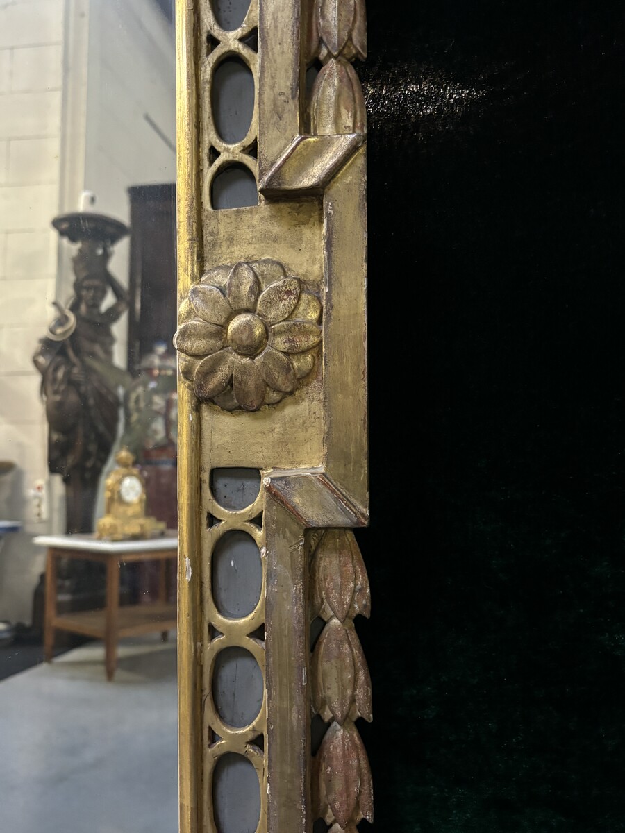 Large 18th century LXVI period mirror in gilded wood ( 184 cm ) Decorative mirror in carved, gilded and patinated wood. Dimensions : Height : 184 cm Width : 85 cm Depth : 5 cm In good condition, 18th century