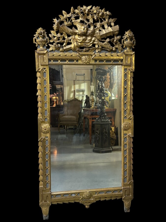 Large 18th century LXVI period mirror in gilded wood ( 184 cm ) Decorative mirror in carved, gilded and patinated wood. Dimensions : Height : 184 cm Width : 85 cm Depth : 5 cm In good condition, 18th century