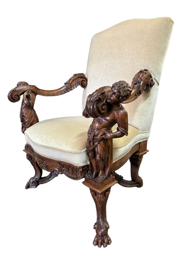 Large 19th century Italian walnut armchair. Very decorative armchair with finely carved walnut figures. Woodwork in good condition, fabric in used condition. Dimensions: Height : 118 cm Width : 96 cm Depth : 78 cm Italy, circa 1860-1870