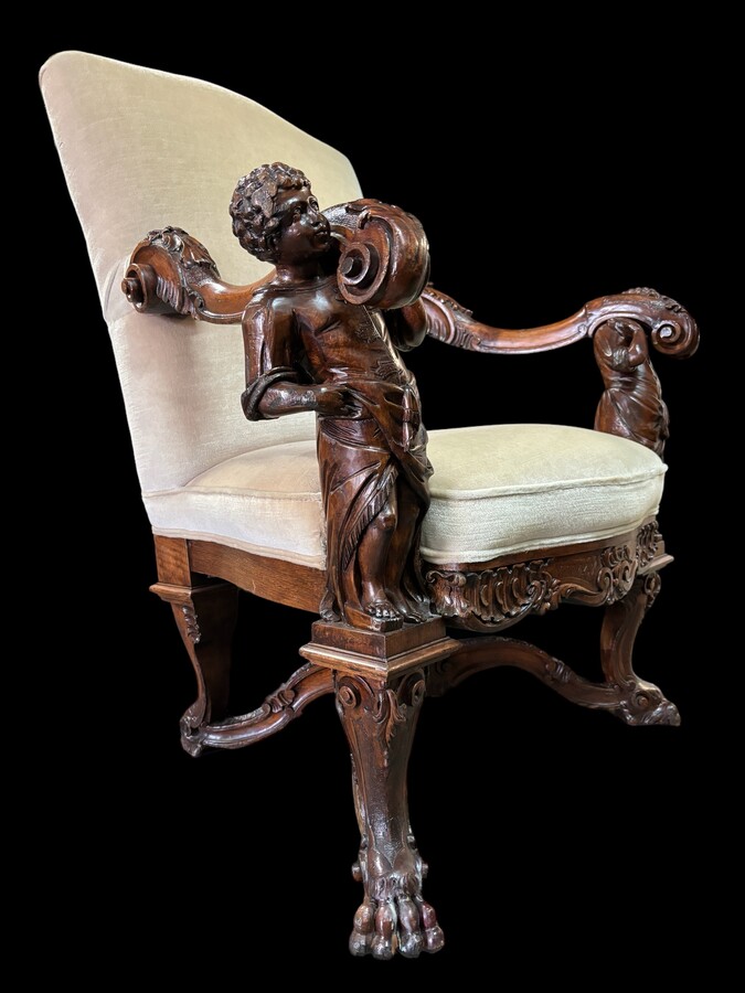Large 19th century Italian walnut armchair. Very decorative armchair with finely carved walnut figures. Woodwork in good condition, fabric in used condition. Dimensions: Height : 118 cm Width : 96 cm Depth : 78 cm Italy, circa 1860-1870