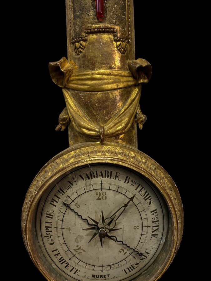 Large Barometer Muret à Paris in gilded wood 18th century Louis Seize decorative barometer in good condition ( cracked glass ) Dimensions : Height : 107 cm Diameter : 25,5 cm Paris, 18th century