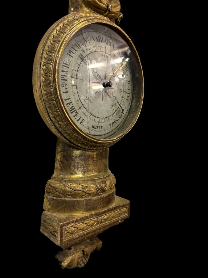 Large Barometer Muret à Paris in gilded wood 18th century Louis Seize decorative barometer in good condition ( cracked glass ) Dimensions : Height : 107 cm Diameter : 25,5 cm Paris, 18th century