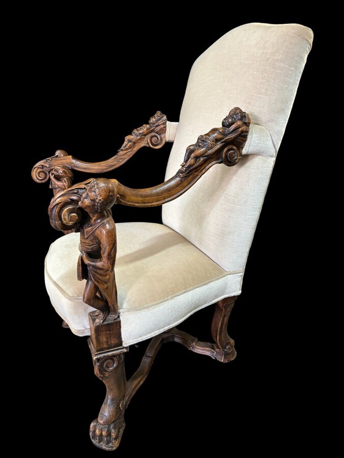 Large Italian armchair in walnut 19thC. Very decorative armchair with finely sculpted people and putti in walnut. Woodwork in good condition , fabric in used condition. Dimensions : Height : 121 cm Width : 86 cm Depth : 78 cm Italy , around 1860-1870