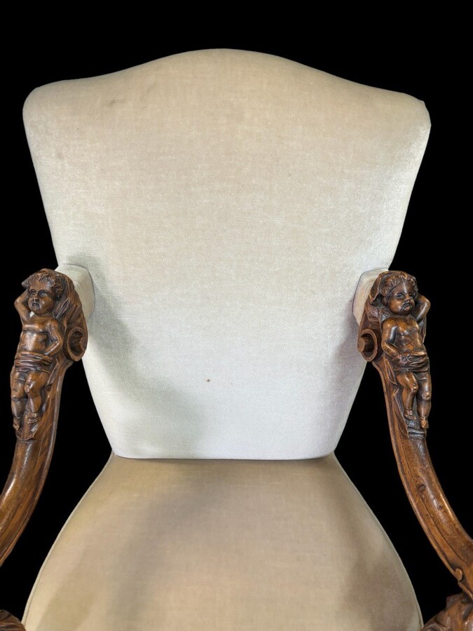 Large Italian armchair in walnut 19thC. Very decorative armchair with finely sculpted people and putti in walnut. Woodwork in good condition , fabric in used condition. Dimensions : Height : 121 cm Width : 86 cm Depth : 78 cm Italy , around 1860-1870