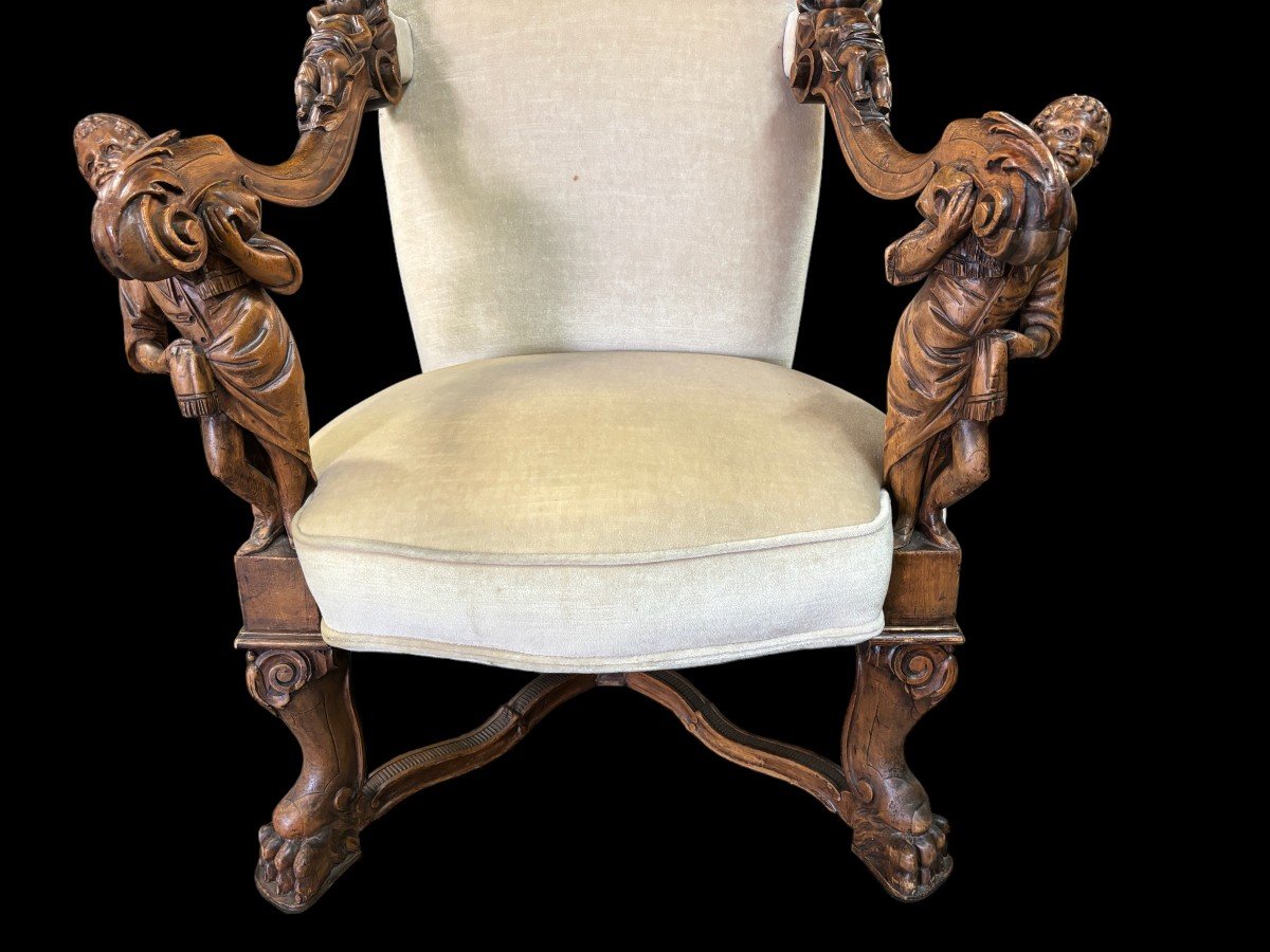 Large Italian armchair in walnut 19thC. Very decorative armchair with finely sculpted people and putti in walnut. Woodwork in good condition , fabric in used condition. Dimensions : Height : 121 cm Width : 86 cm Depth : 78 cm Italy , around 1860-1870