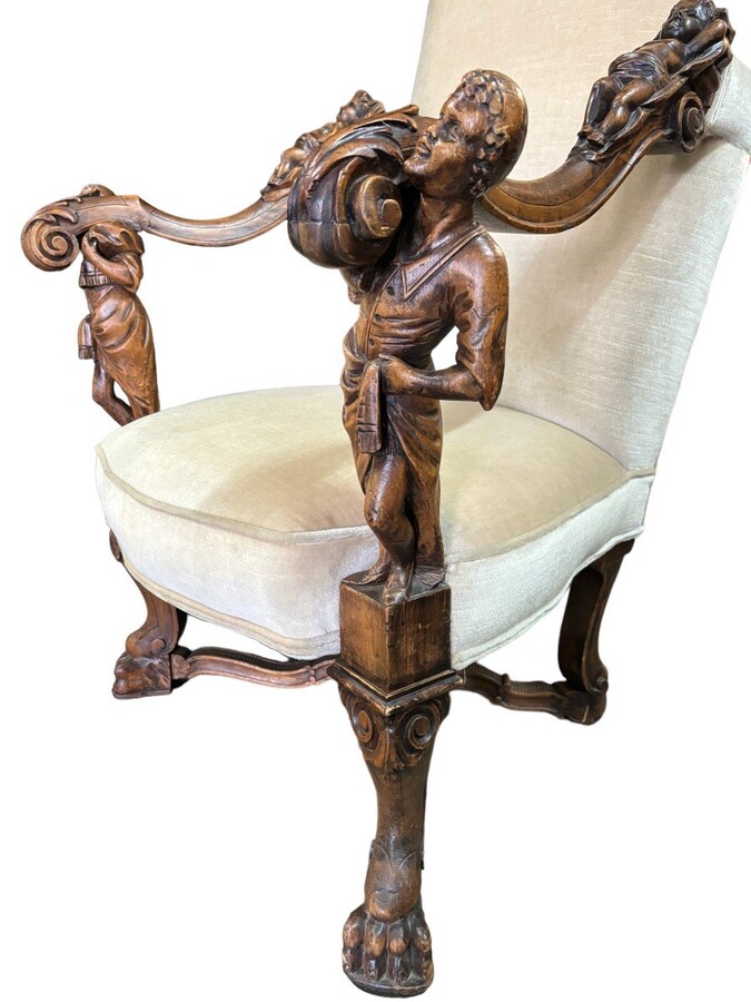 Large Italian armchair in walnut 19thC. Very decorative armchair with finely sculpted people and putti in walnut. Woodwork in good condition , fabric in used condition. Dimensions : Height : 121 cm Width : 86 cm Depth : 78 cm Italy , around 1860-1870