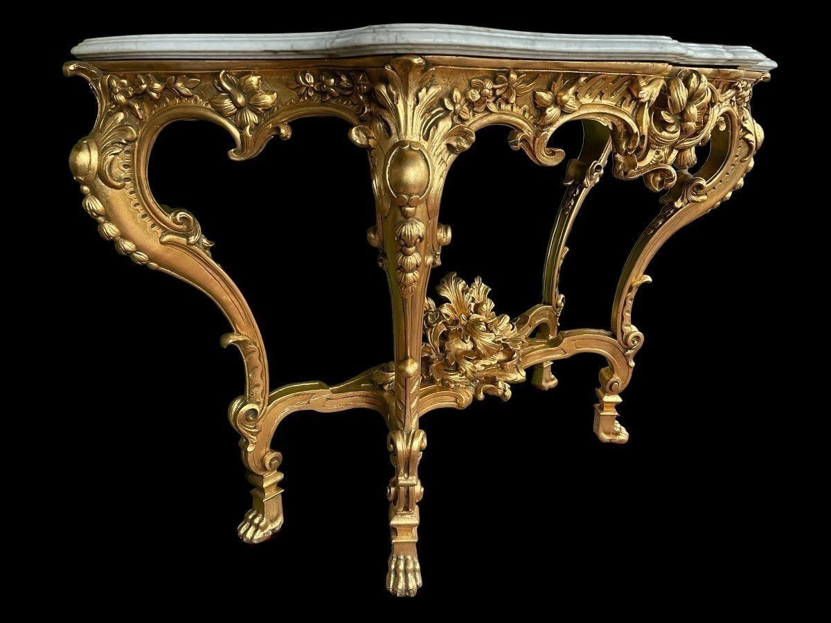 Large Louis XV style 4 legs console in gilded wood/stucco 19th century. Decorative console with a nice thick white marble top. The console and the marble top are in good condition and stand on 4 claw feet. It dates from about 1880-1900.