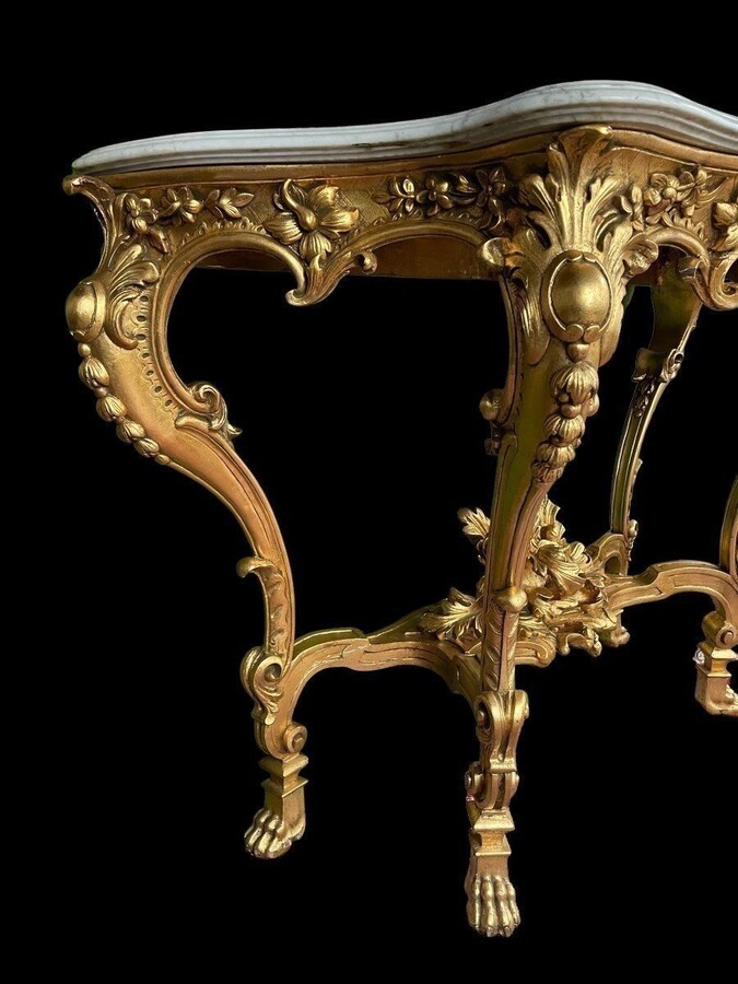 Large Louis XV style 4 legs console in gilded wood/stucco 19th century. Decorative console with a nice thick white marble top. The console and the marble top are in good condition and stand on 4 claw feet. It dates from about 1880-1900.