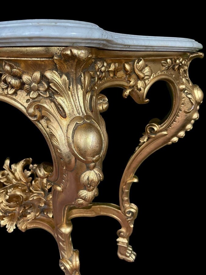 Large Louis XV style 4 legs console in gilded wood/stucco 19th century. Decorative console with a nice thick white marble top. The console and the marble top are in good condition and stand on 4 claw feet. It dates from about 1880-1900.