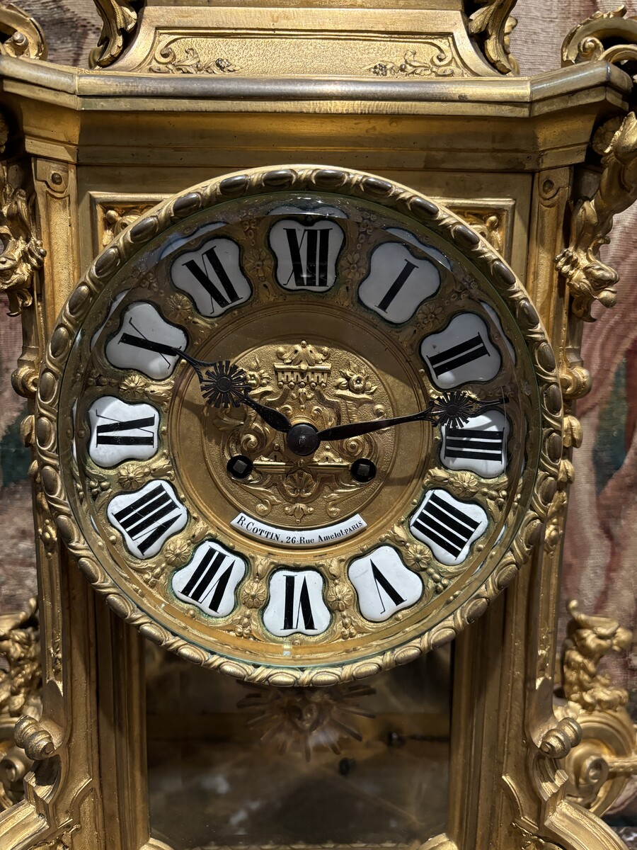 Large pendulum clock in gilt bronze with cut glass 19th century. Representation of Chronos figure , winged Mythological beasts and decorations in bronze working with a suns balance. Richly decorated dial signed R.COTTIN.26 Rue Amelot PARIS