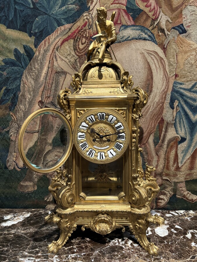 Large pendulum clock in gilt bronze with cut glass 19th century. Representation of Chronos figure , winged Mythological beasts and decorations in bronze working with a suns balance. Richly decorated dial signed R.COTTIN.26 Rue Amelot PARIS