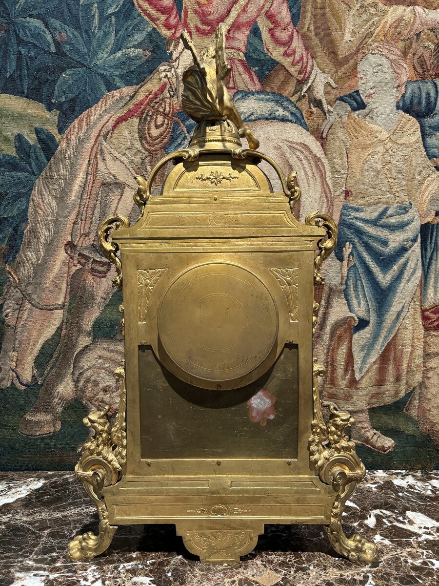 Large pendulum clock in gilt bronze with cut glass 19th century. Representation of Chronos figure , winged Mythological beasts and decorations in bronze working with a suns balance. Richly decorated dial signed R.COTTIN.26 Rue Amelot PARIS