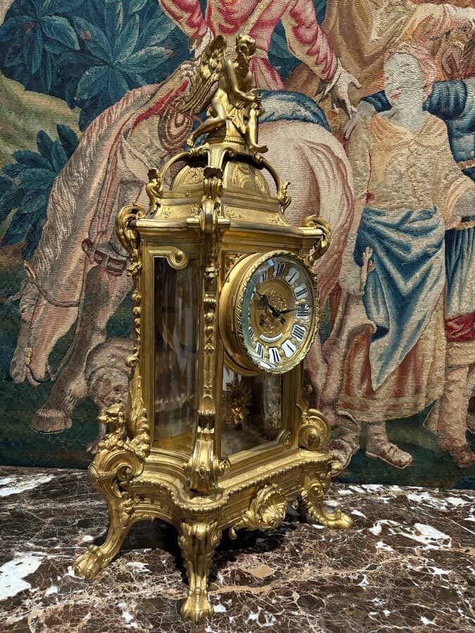 Large pendulum clock in gilt bronze with cut glass 19th century. Representation of Chronos figure , winged Mythological beasts and decorations in bronze working with a suns balance. Richly decorated dial signed R.COTTIN.26 Rue Amelot PARIS