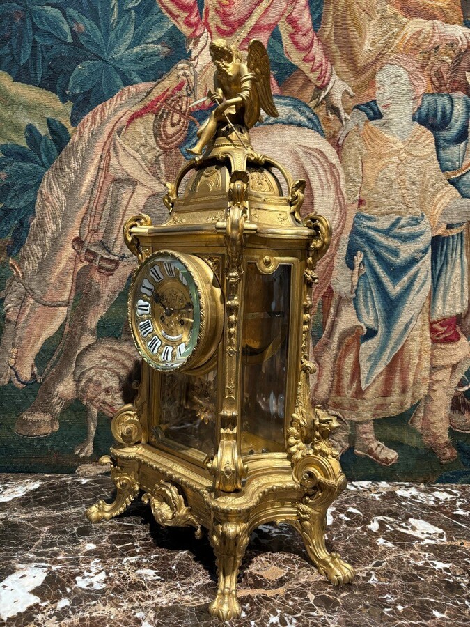 Large pendulum clock in gilt bronze with cut glass 19th century. Representation of Chronos figure , winged Mythological beasts and decorations in bronze working with a suns balance. Richly decorated dial signed R.COTTIN.26 Rue Amelot PARIS